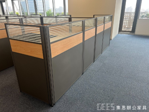 新竹市112cm平衡型出字形OA屏風工作站實景,鐵灰色框架結合鐵灰色面板、木紋面板與條紋玻璃,以寬敞桌面規劃13人以上外商職員辦公座位